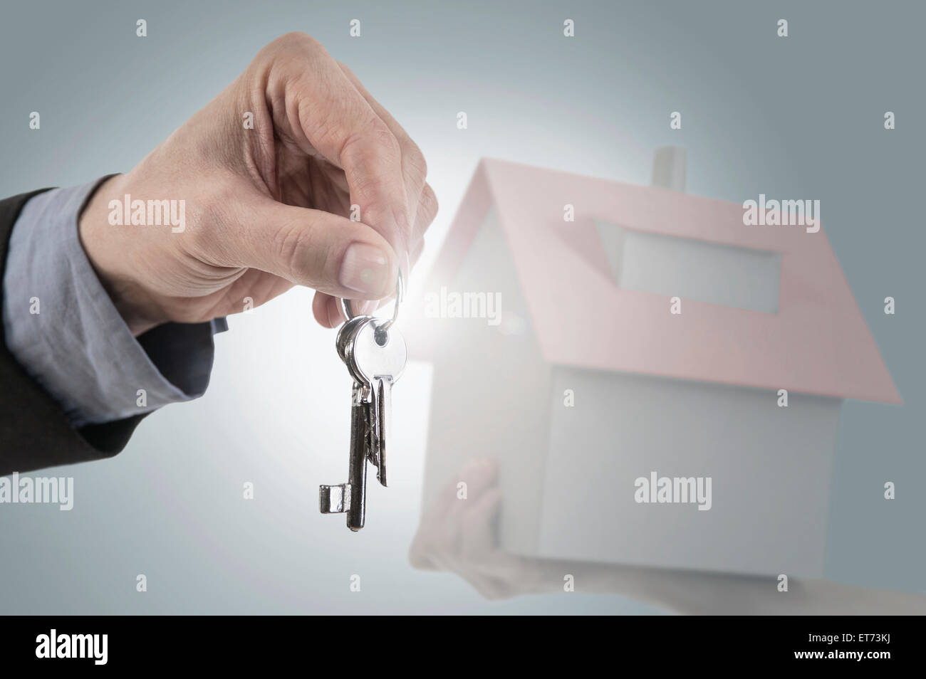 Hand with house model and keys hi-res stock photography and images - Alamy