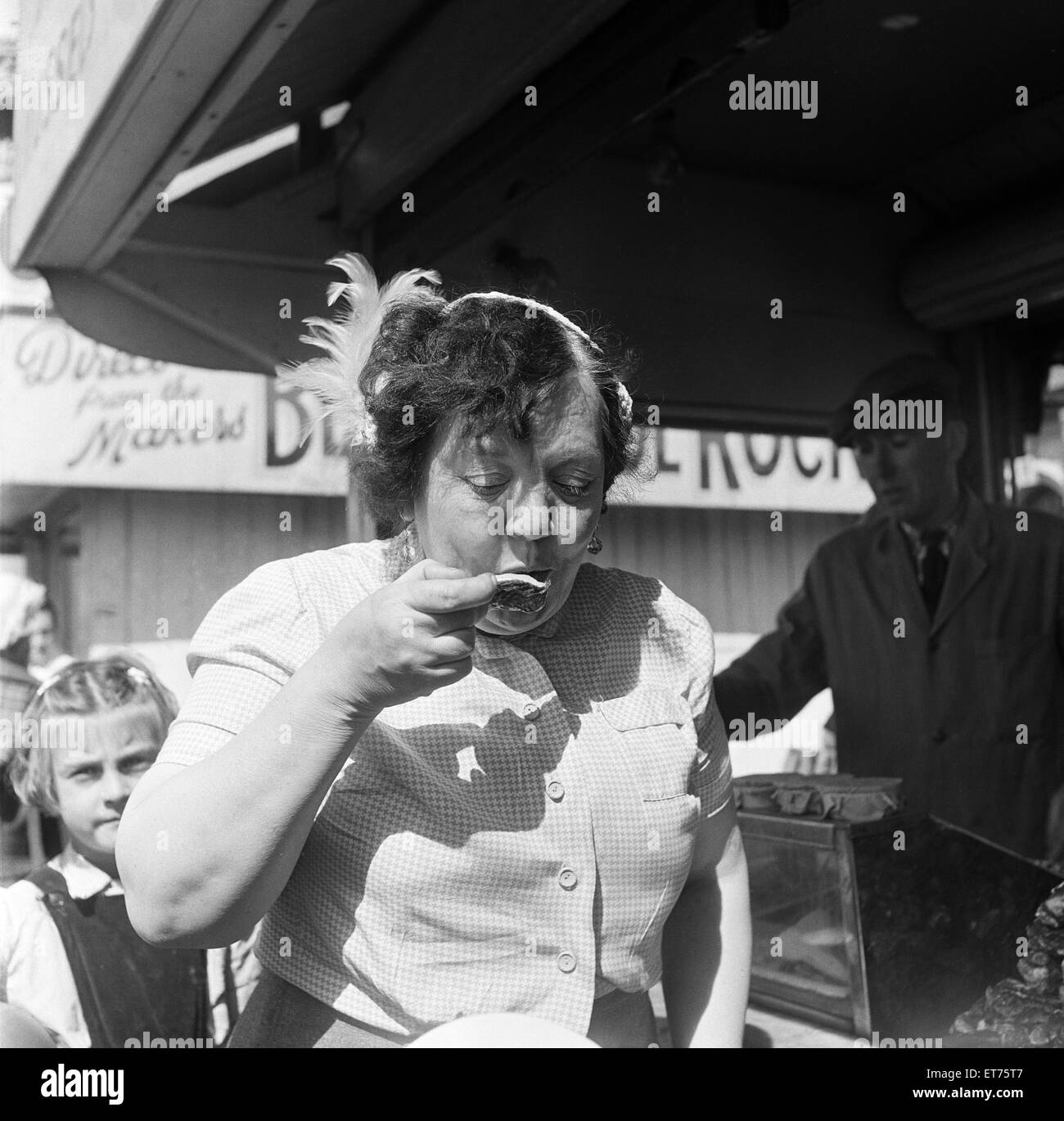 A woman eating oysters whilst on holiday in Blackpool, Lancashire. 3rd August 1953. Stock Photo