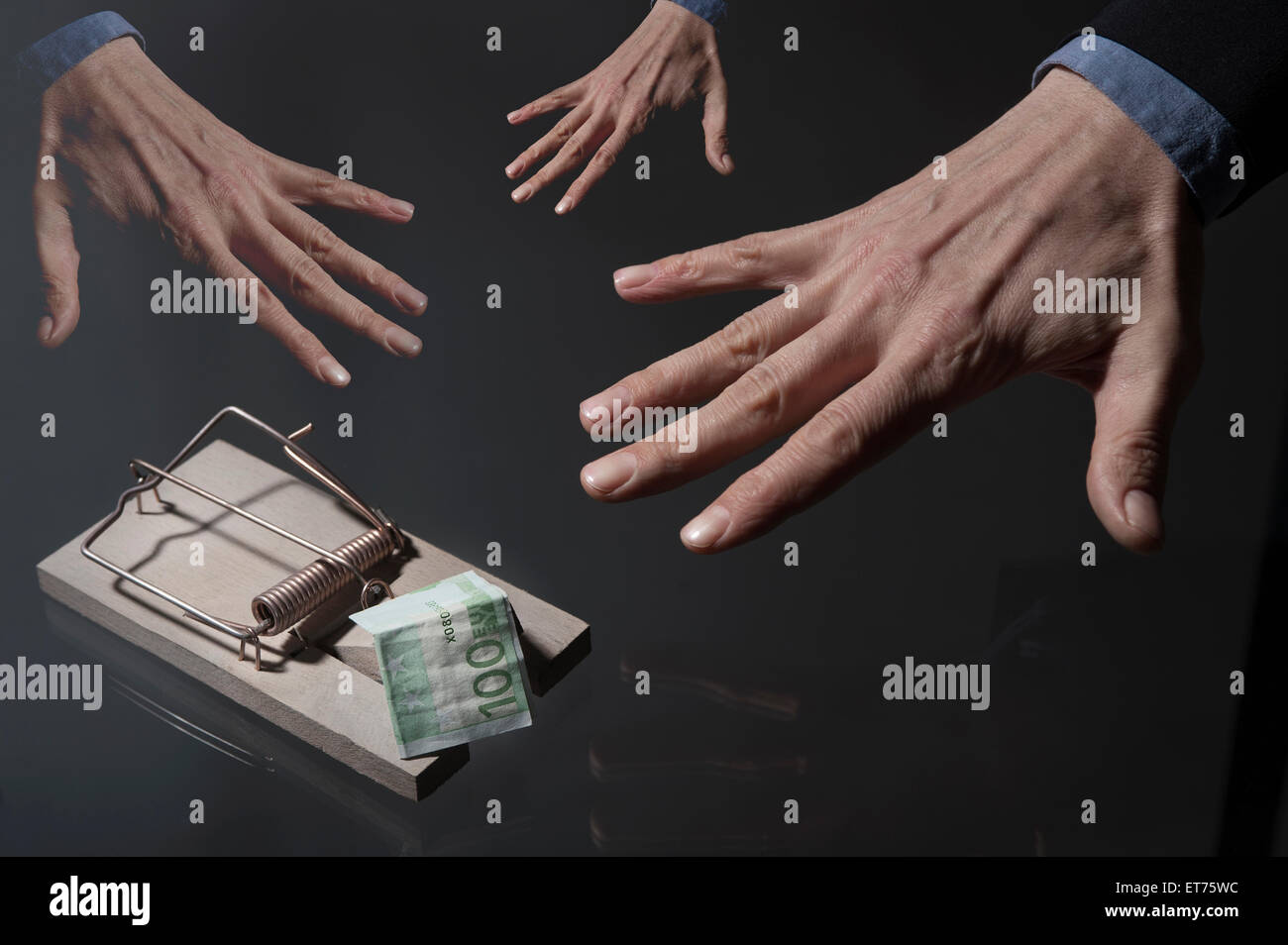businessman's hands reaching for money in mousetrap, Bavaria, Germany Stock Photo