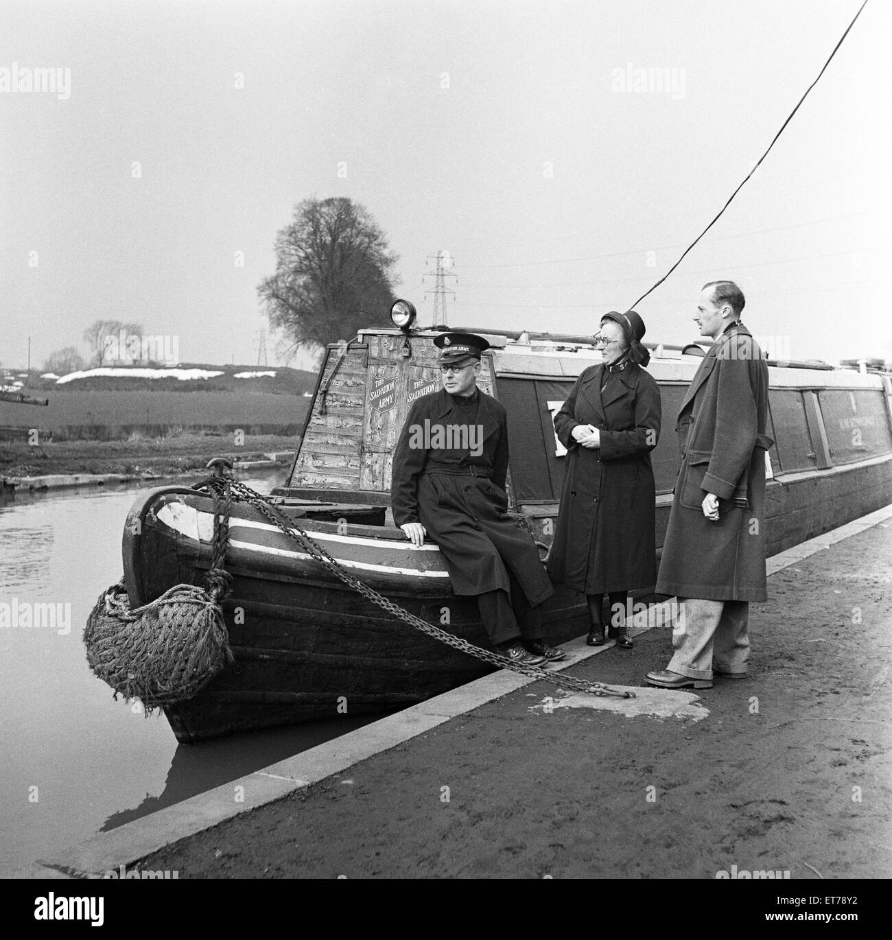 Members of the Salvation Army stand next to their barge. April 1954 Stock Photo
