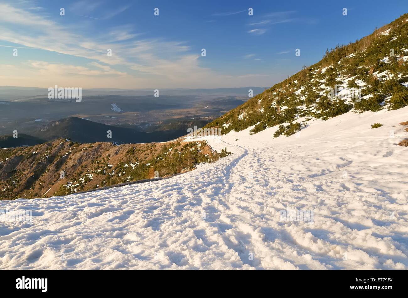 Winter mountain landscape. Snowy trail leading to the valley with view of highland, National Park in the Tatra Mountains, Poland Stock Photo