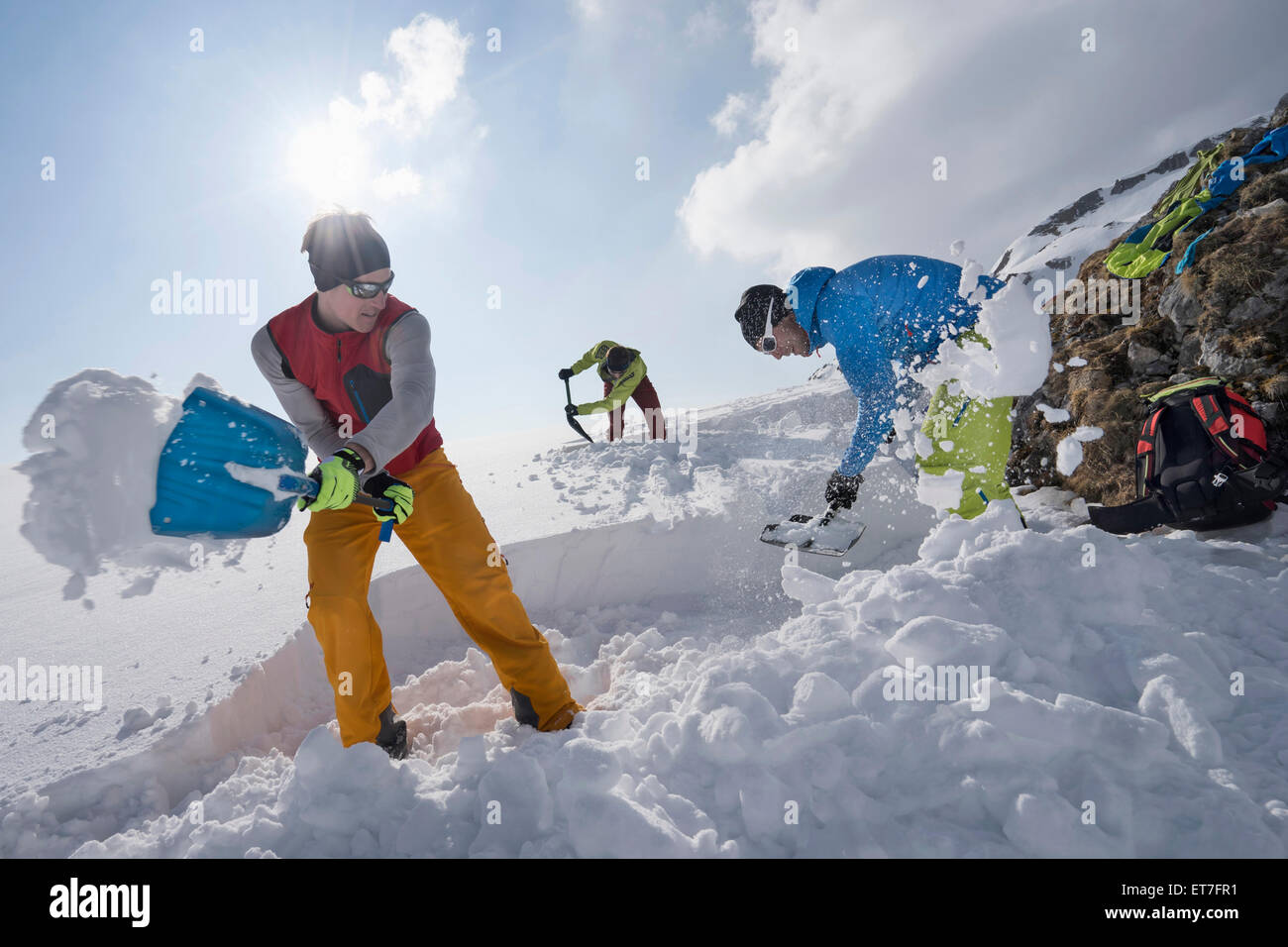 Men shovelling snow for bivouac camp, Tyrol, Austria Stock Photo