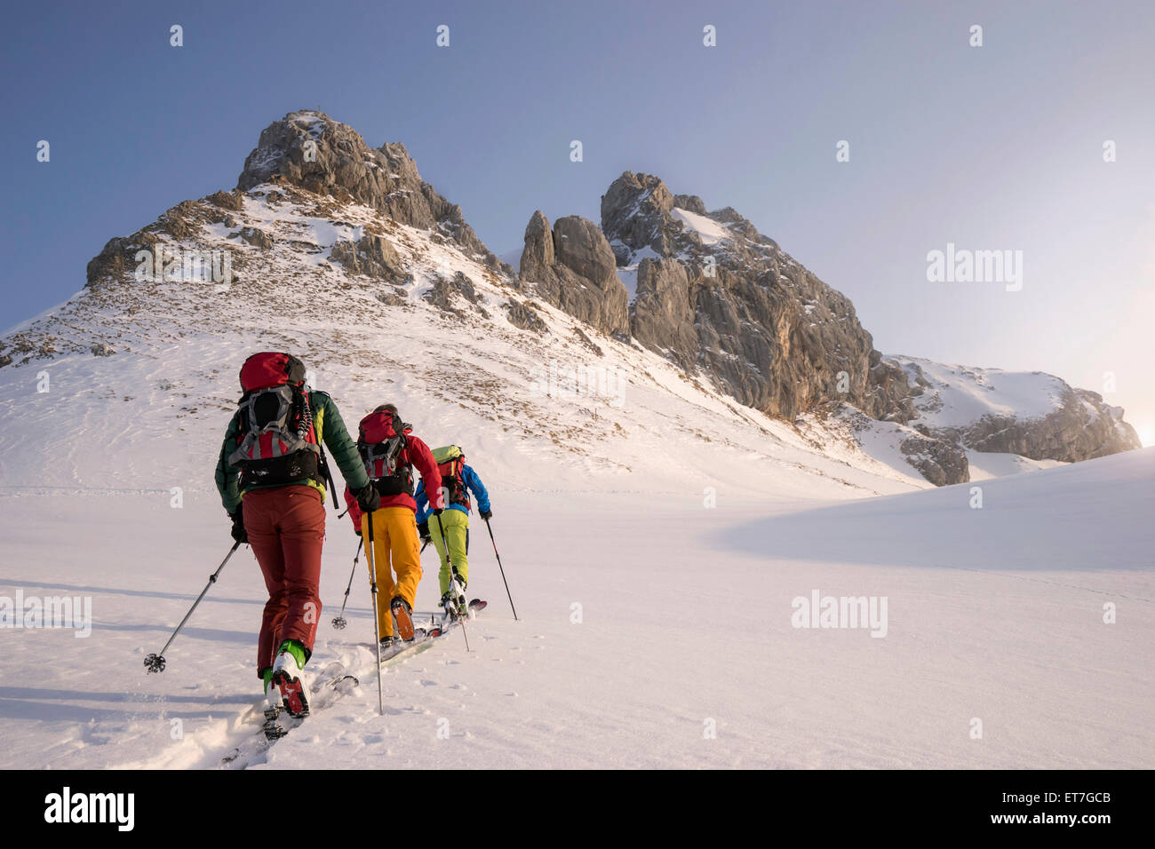 Ski mountaineers climbing on snowy peak, Tyrol, Austria Stock Photo