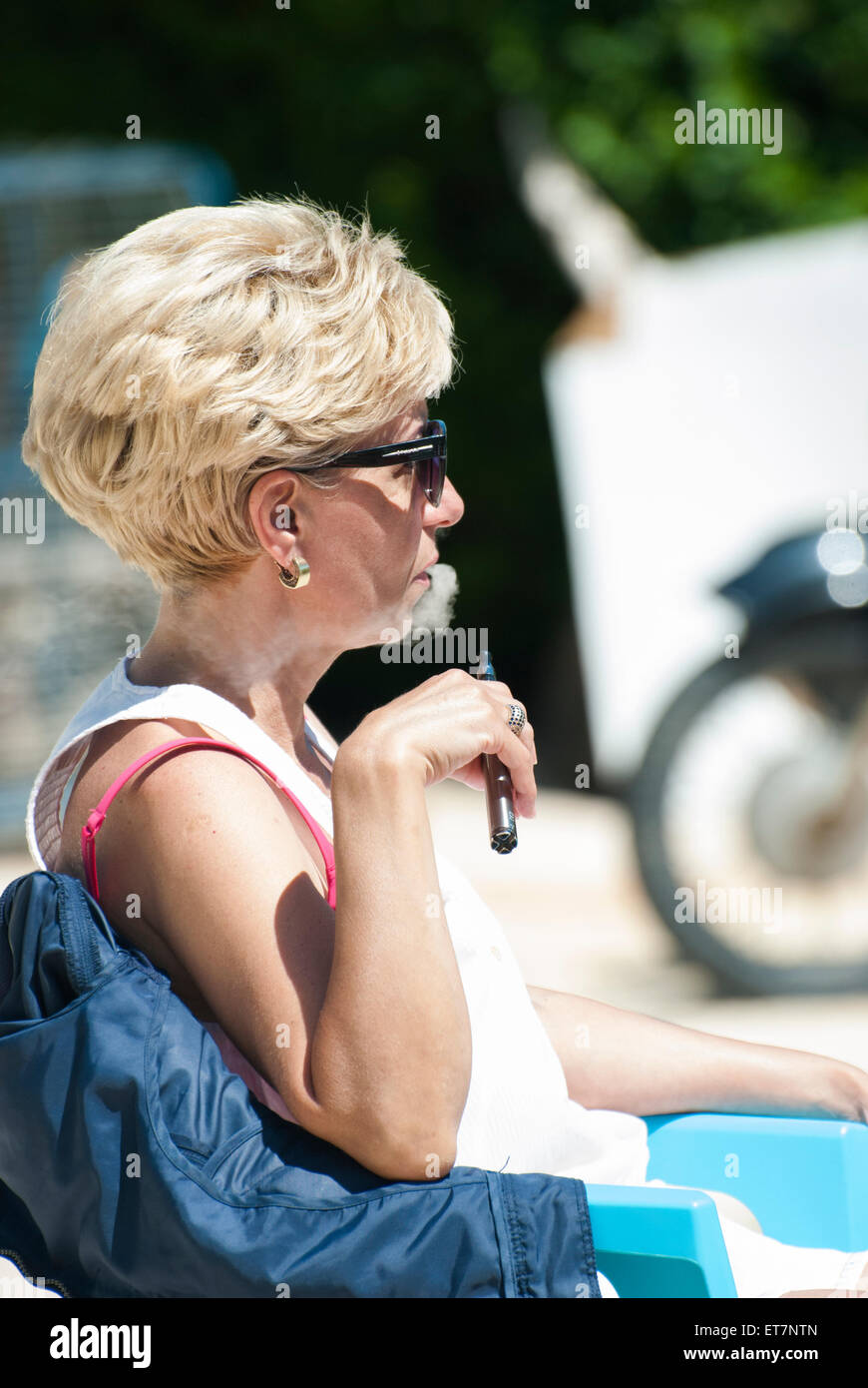 Woman vaping electronic cigarette Stock Photo