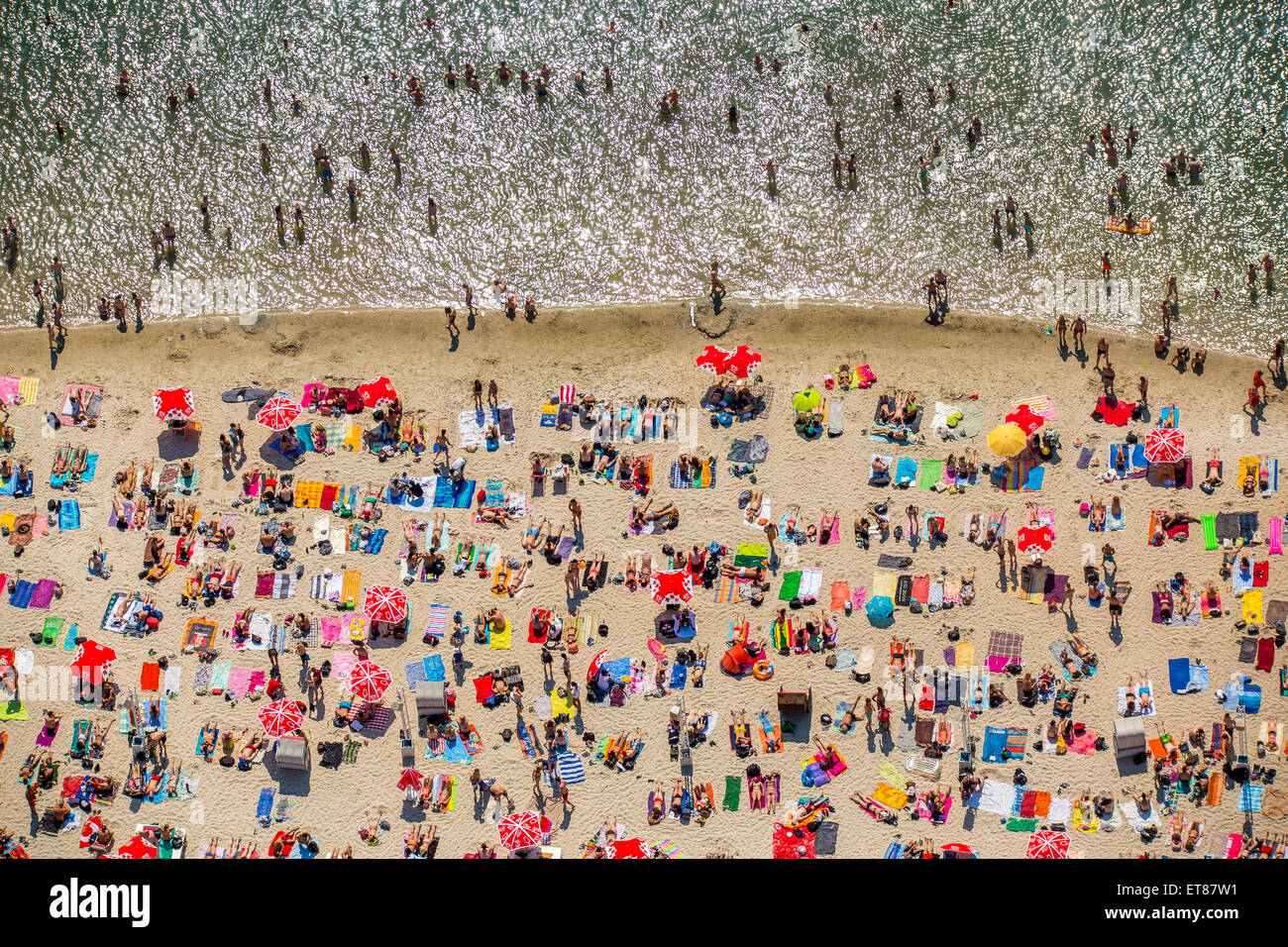 Sundown Beach, bathers on towels at Escher lake, lake in Cologne, Rhineland, North Rhine-Westphalia, Germany Stock Photo