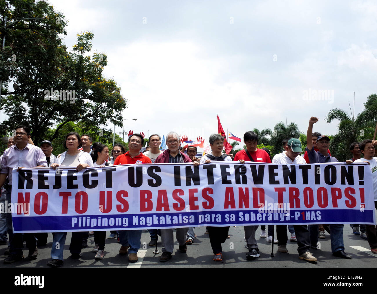 Manila, Philippines. 12th June, 2015. Filipino former senator Rene Saguisag, fifth from left, marches towards US embassy alongside protesters during a protest action in commemoration of the 117th Philippine Independence Day. Hundreds of protesters from different groups assailed the allegedly increased US intervention on the territorial dispute in South China Sea. Credit:  Richard James Mendoza/Pacific Press/Alamy Live News Stock Photo