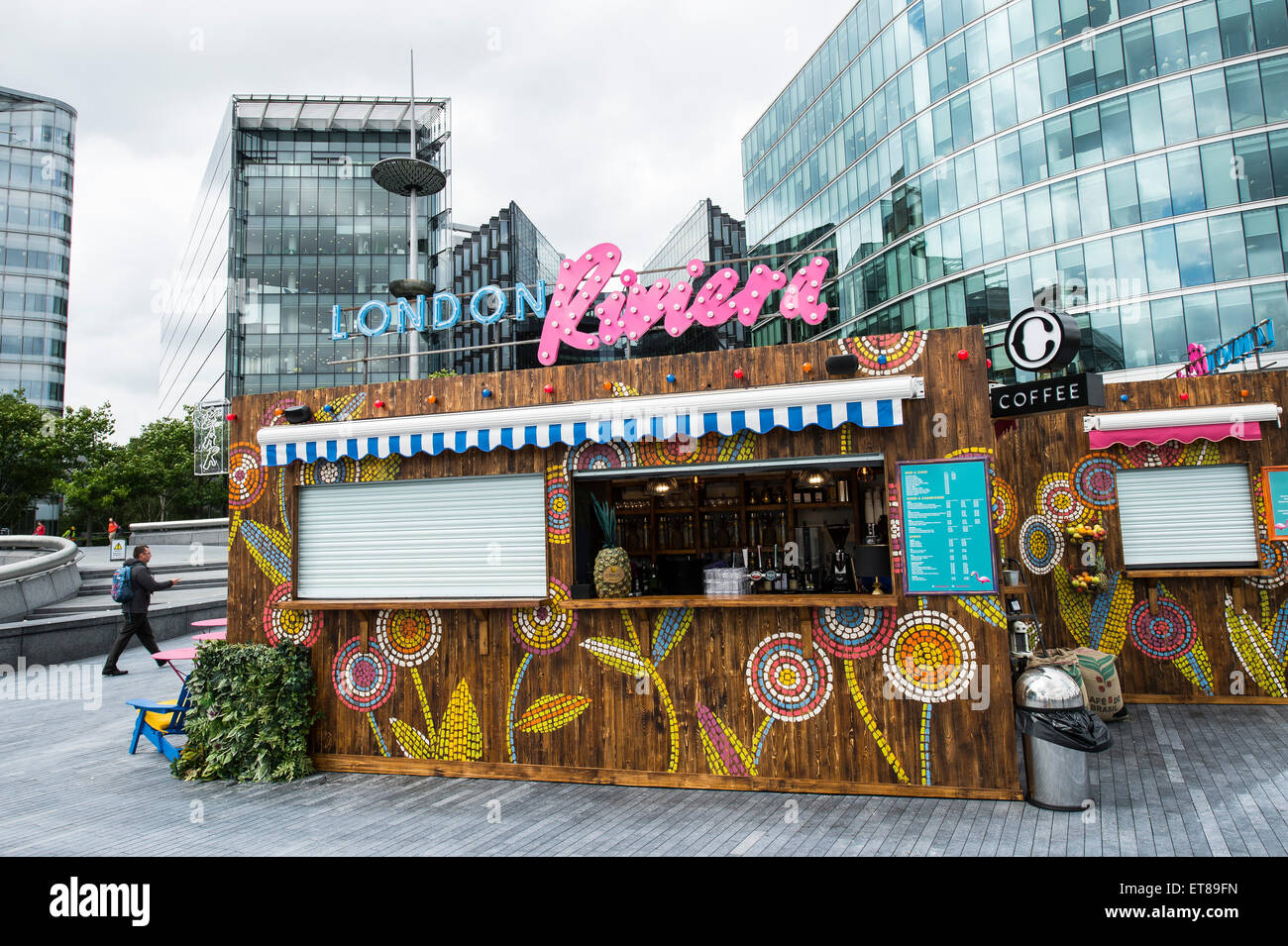 London Riviera Pop Up Restaurant next to City Hall in London with colourful deck chairs and fake crocodile table with city views Stock Photo