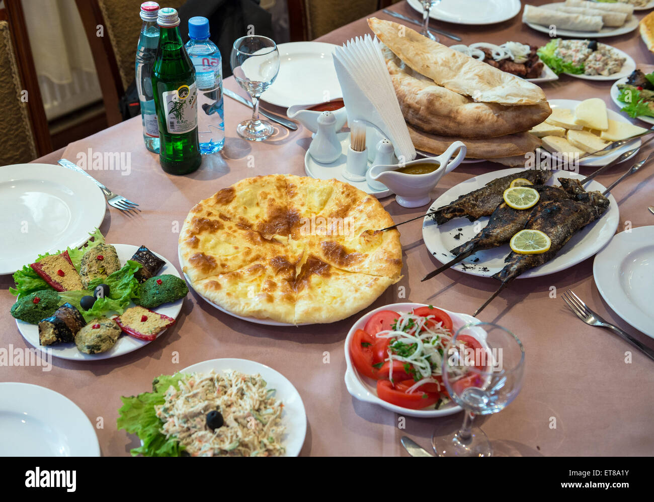 Georgian traditional food like Imeretian khachapuri, roasted fishes and Pkhali salad Stock Photo