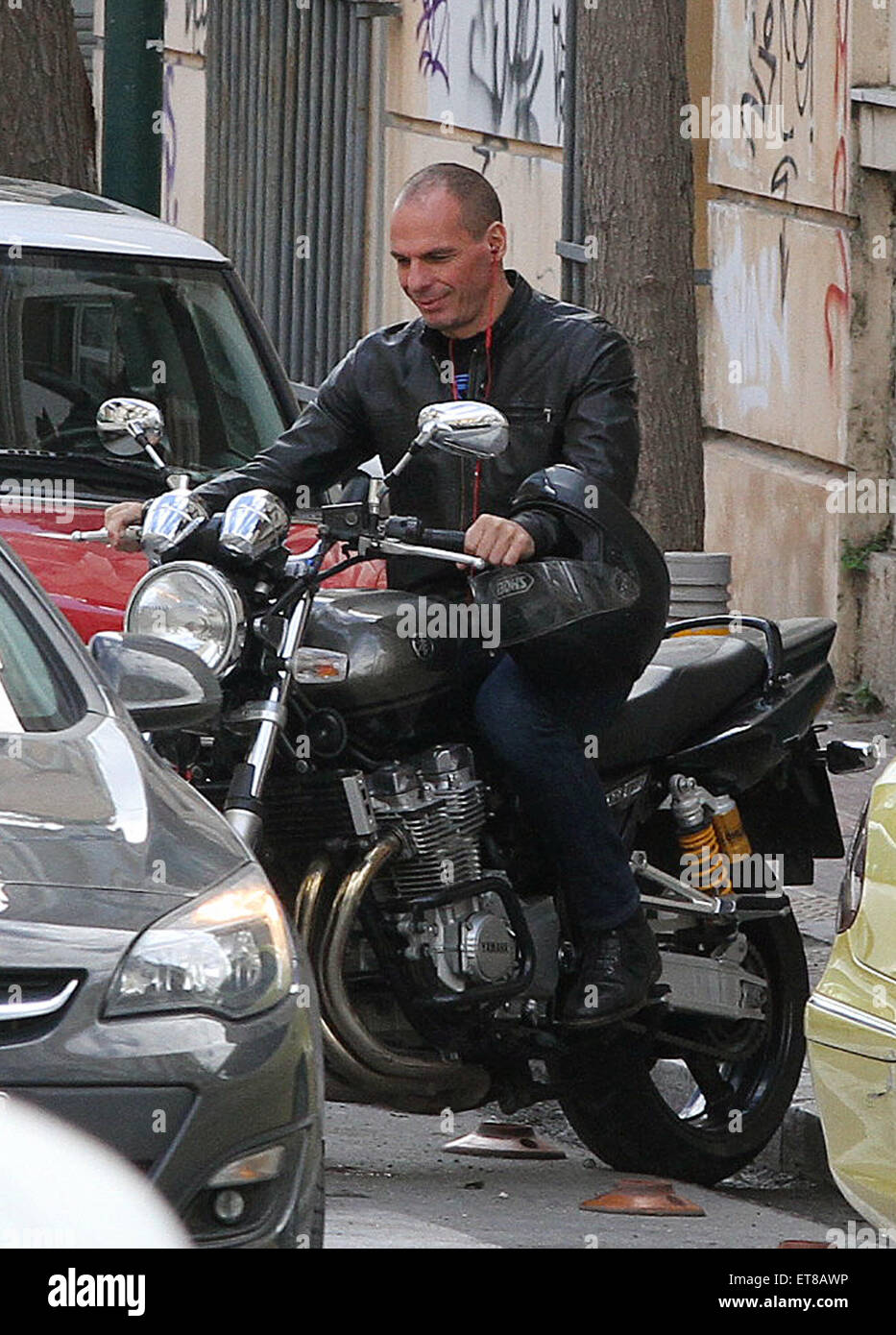 Yanis Varoufakis gets on his motorcycle parked near his home. The Greek  Finance Minister believes that a referendum could be held if a deal can not  be reached on Greece's proposed debt