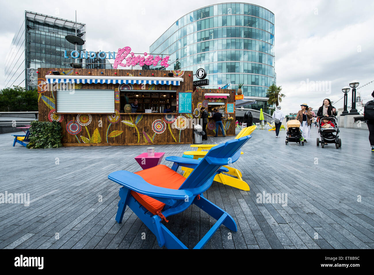 London Riviera pop up cafe at More London next to City Hall with colourful chairs Stock Photo