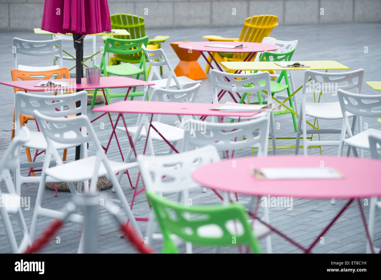 London Riviera Pop Up Restaurant next to City Hall in London with colourful  deck chairs and fake crocodile table with city views Stock Photo - Alamy