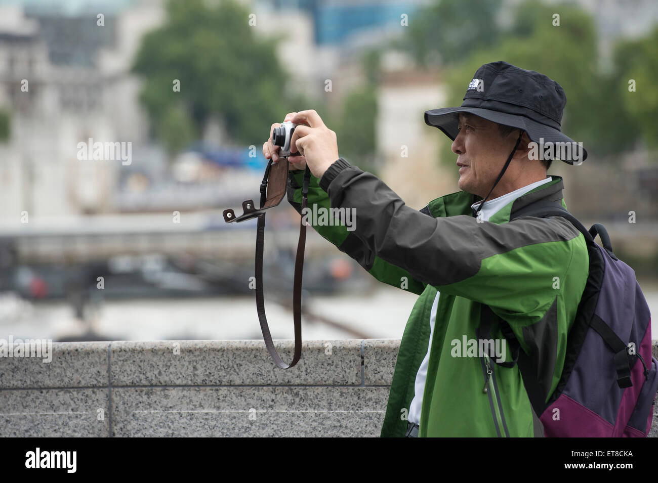 Japanese tourist taking pictures in London with cameras, phones and selfie sticks Stock Photo