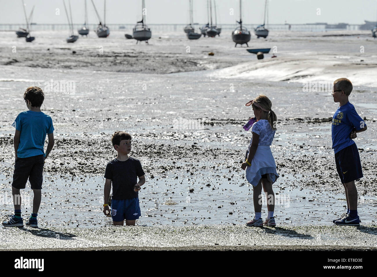 Children playing on the foreshore at Leigh on Sea in Essex. Stock Photo