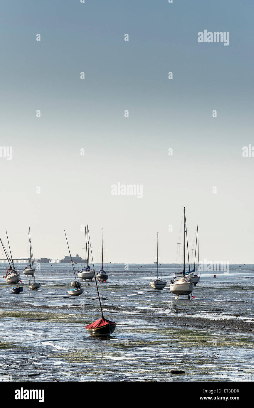 Boats moored on the mudflats of the Thames Estuary at low tide. Stock Photo