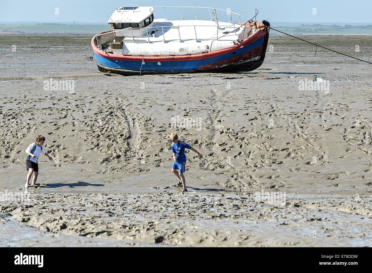 Two boys playing in the mud at Leigh on Sea in Essex. Stock Photo