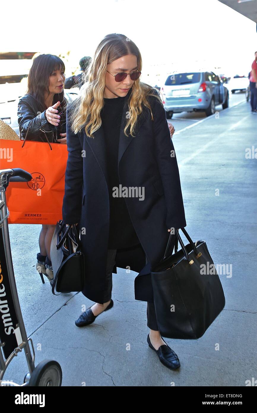 Ashley Olsen with a Tory Burch bag at Los Angeles International Airport (LAX)  Featuring: Ashley Olsen Where: Los Angeles, California, United States When:  23 Dec 2014 Credit:  Stock Photo - Alamy