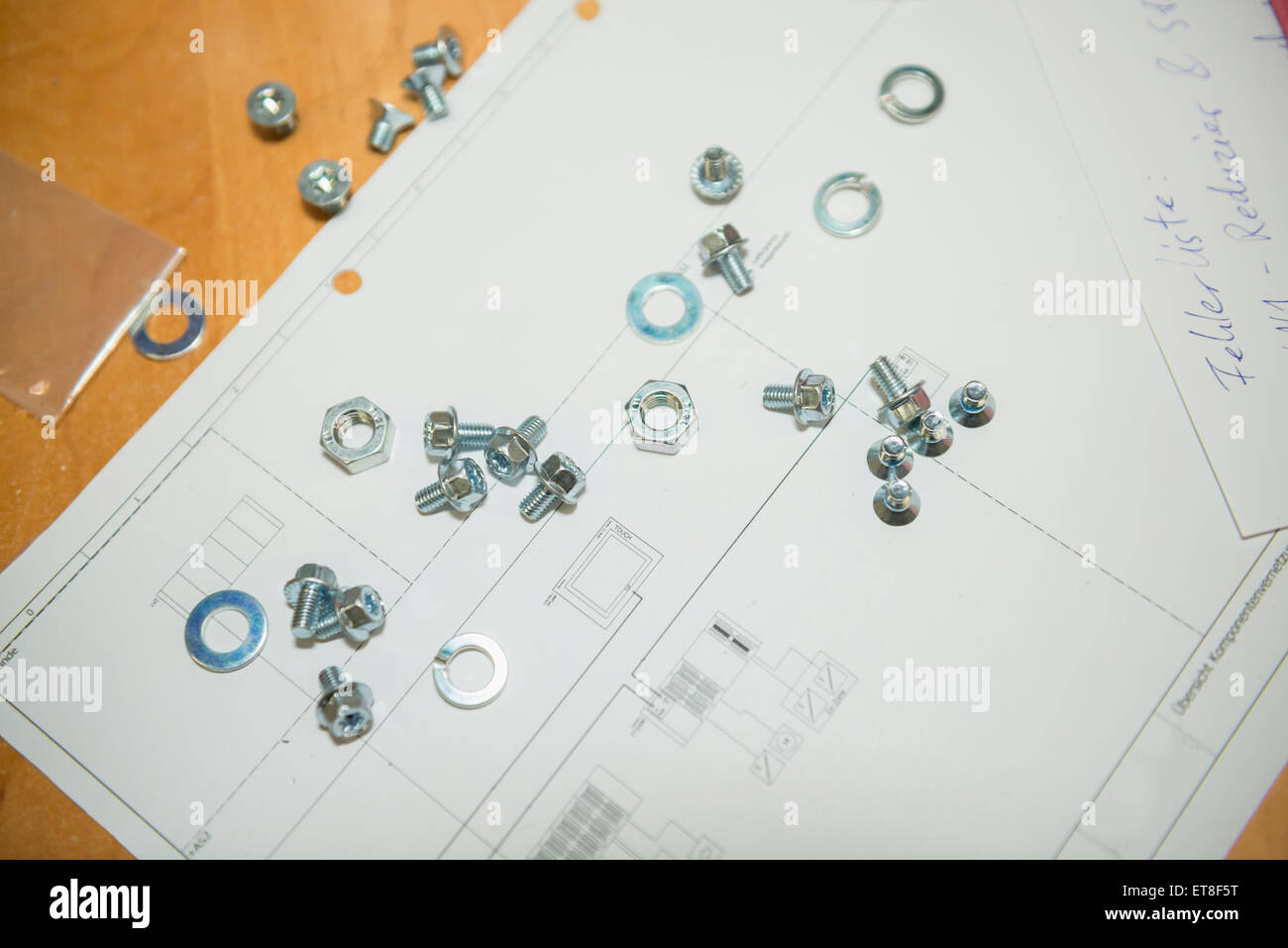 Nuts with bolts and washers on blueprint, Munich, Bavaria, Germany Stock Photo
