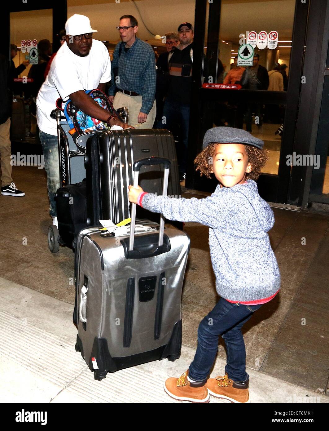 R&B singer-songwriter, Bobby Brown struggles with his luggage as he