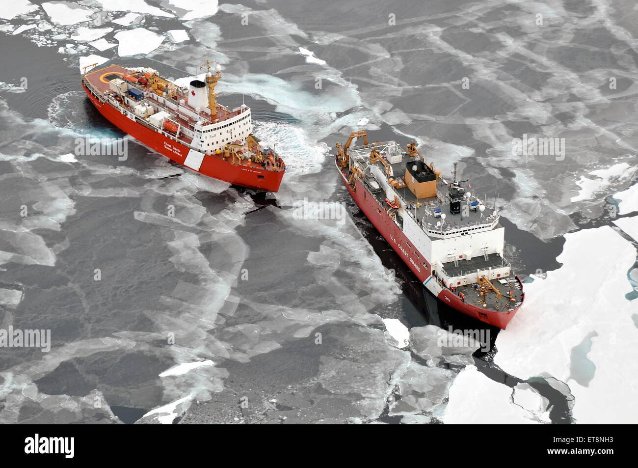 US Coast Guard Cutter Healy breaks ice alongside the Canadian Coast Guard heavy icebreaker CCGS Louis S. St-Laurent September 5, 2009 in the Arctic. Stock Photo