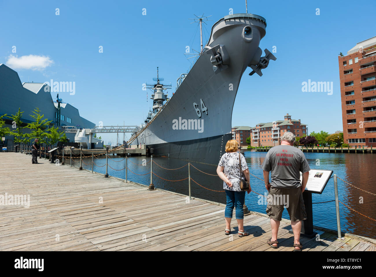 A couple reads information about Battleship Wisconsin at the Nauticus museum in Norfolk, Virginia. Stock Photo