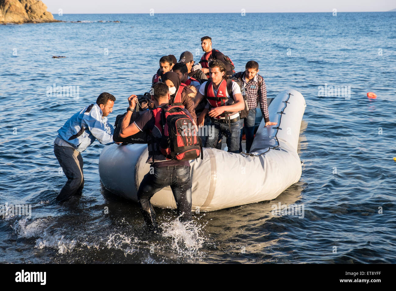 Refugees from Syria and Afghanistan reach the shores of the Greek island of Lesvos after crossing in rafts from Turkey Stock Photo