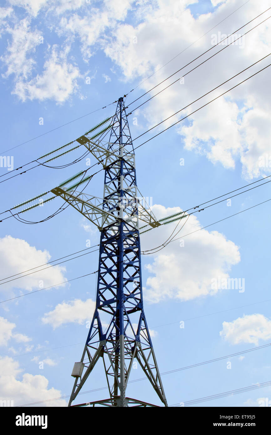 Electricity pylon against blue cloudy sky Stock Photo - Alamy