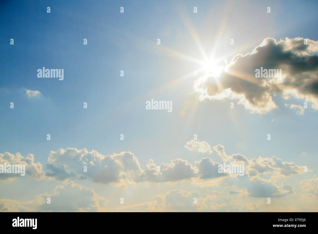 Blue sky with clouds and sun. Stock Photo