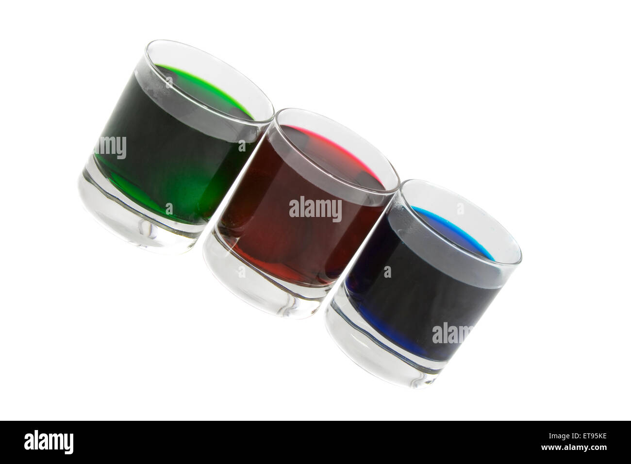 Three glasses with multicoloured cocktails isolated over white Stock