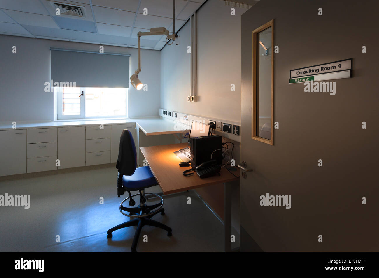 Unoccupied hospital consulting room with sign on door Stock Photo