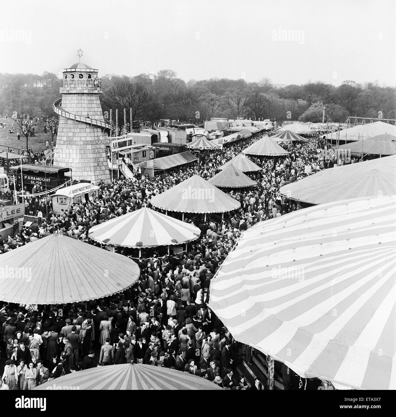 The fine weather brought the crowds out to Happy Hampstead. The famous fair ground at one time was so crowded people were reduced to a snails pace, the money was turning and every side show took its quote. Easter Fair, Hampstead Heath, London. 14th April Stock Photo