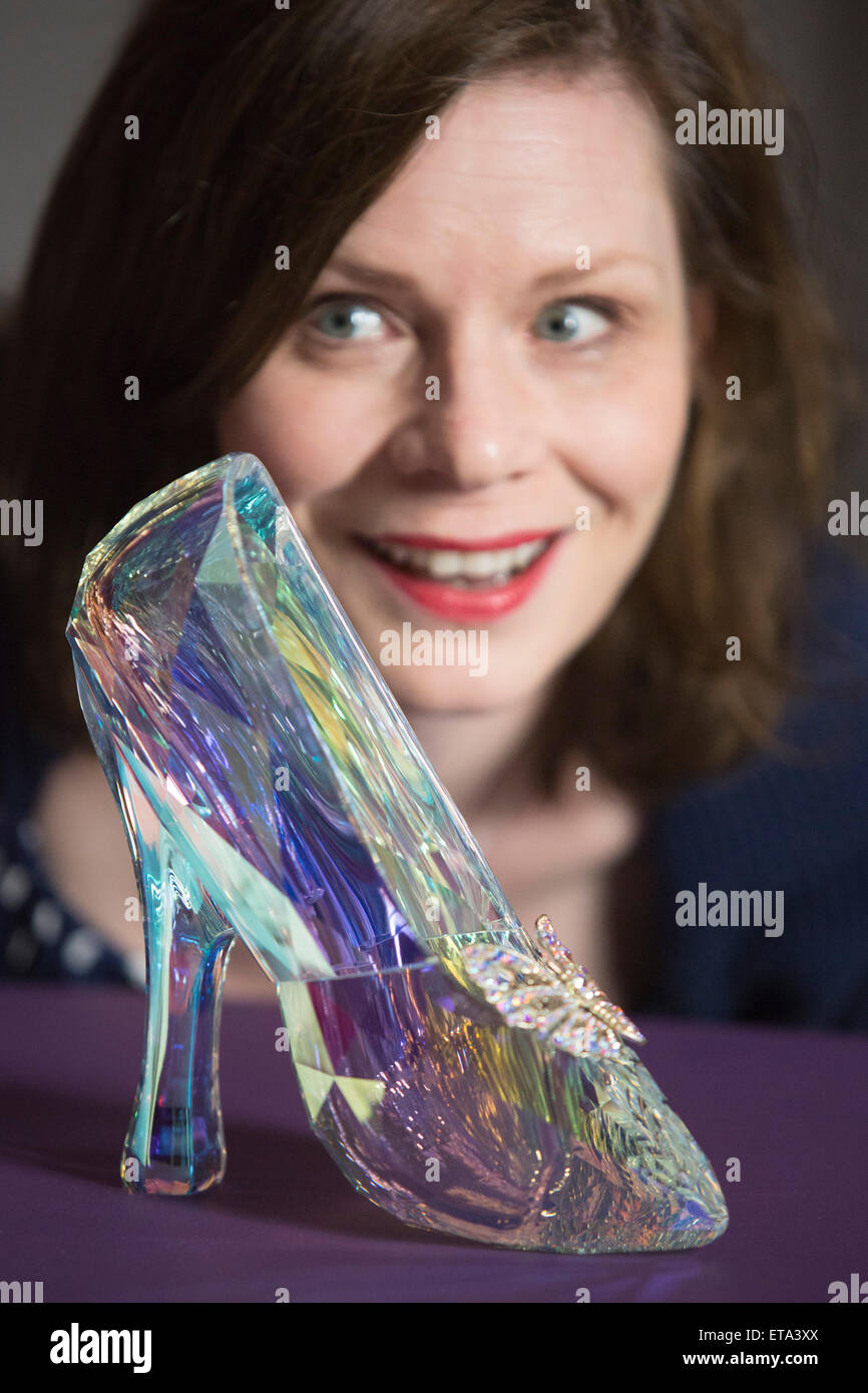 Curator Helen Persson holds Disney's Cinderella slipper ahead of the new  V&A summer fashion exhibition "Shoes: Pleasure and Pain" which focuses on  the transformative power of shoes. The slipper was created by