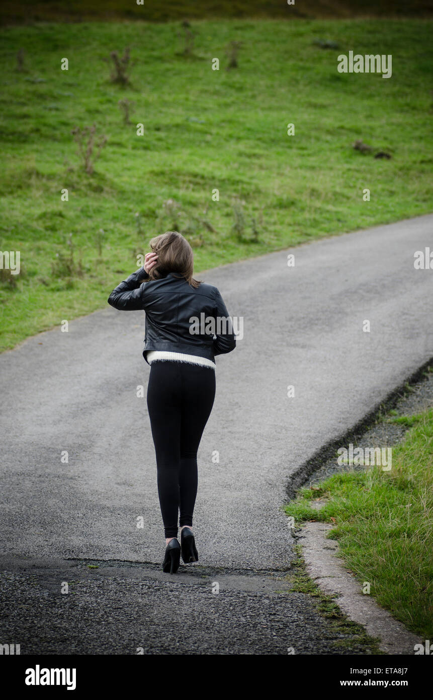 Young woman walking in the countryside Stock Photo