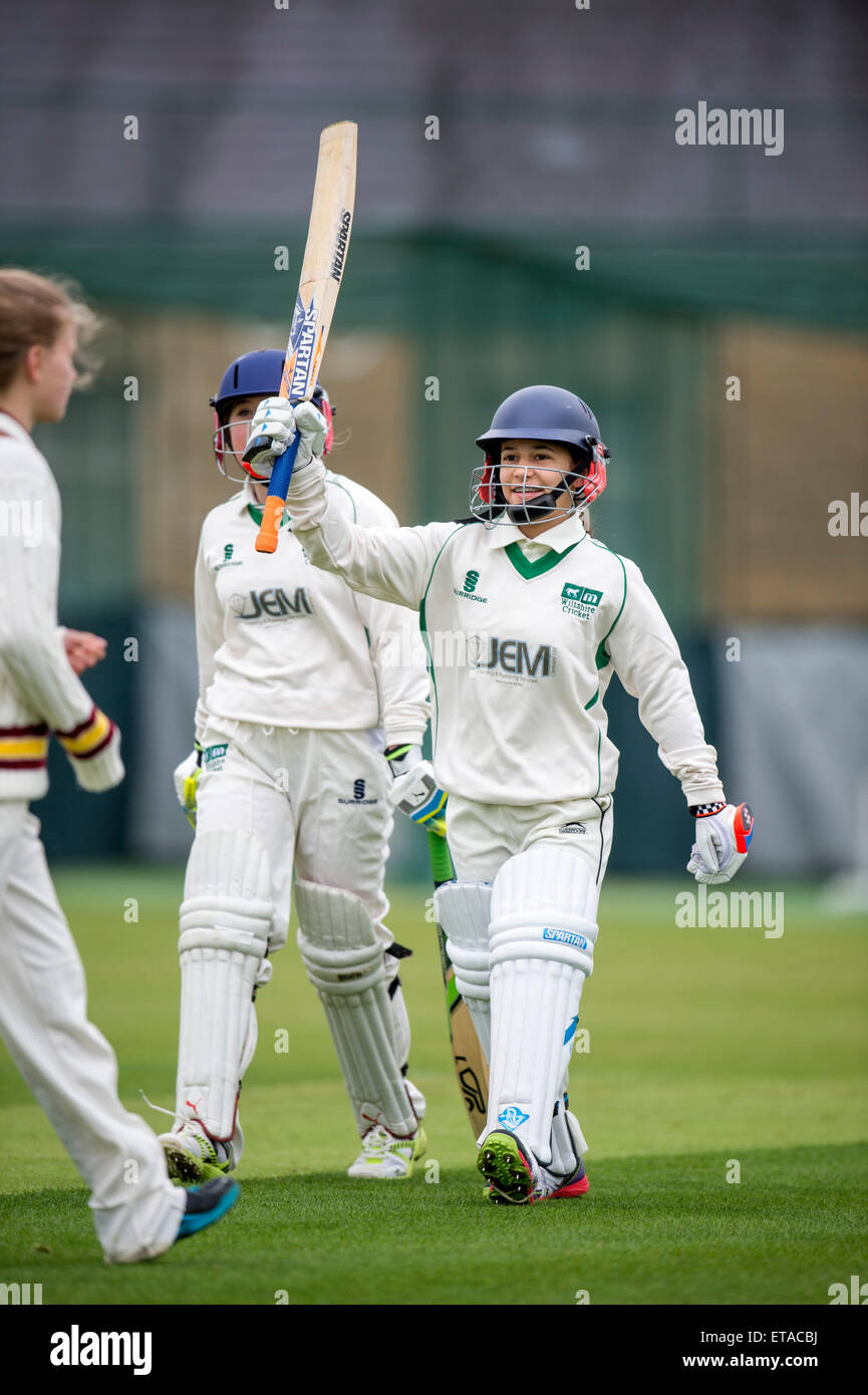 A batsman celebrates her 50 junior during a girls cricket match in