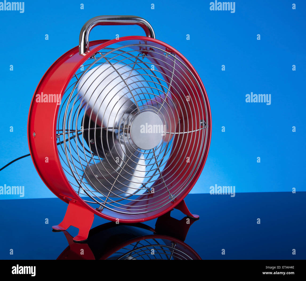 Red Color Fan Red Fan on blue background for summer cooling Stock Photo - Alamy