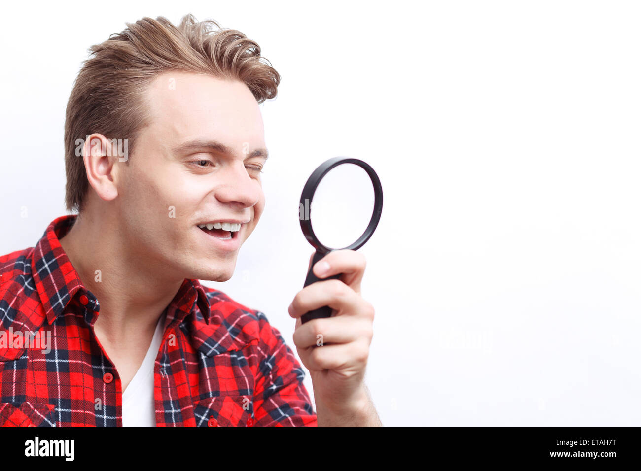 Agreeable guy keeping loupe Stock Photo