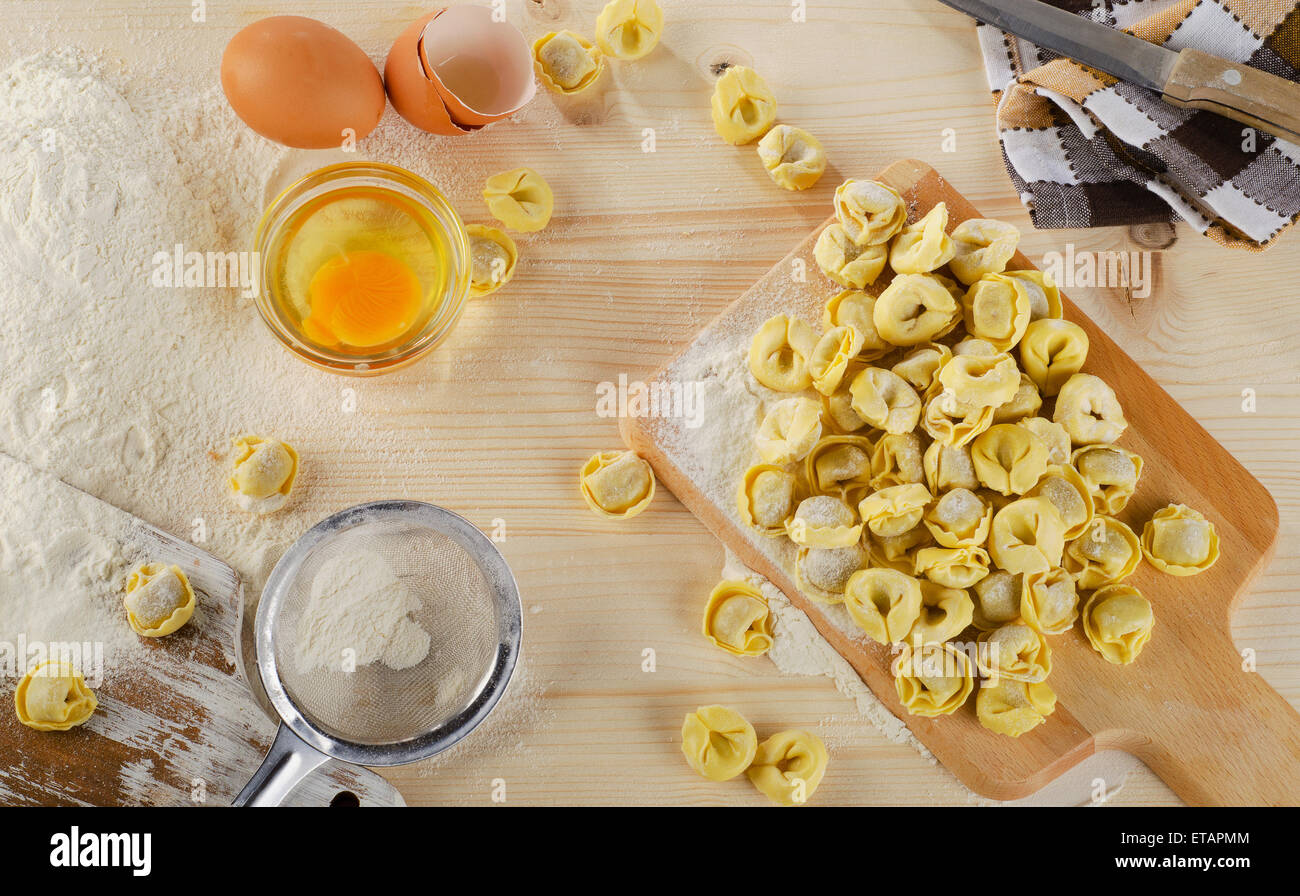 Uncooked Ravioli on a  wooden board.Top view Stock Photo