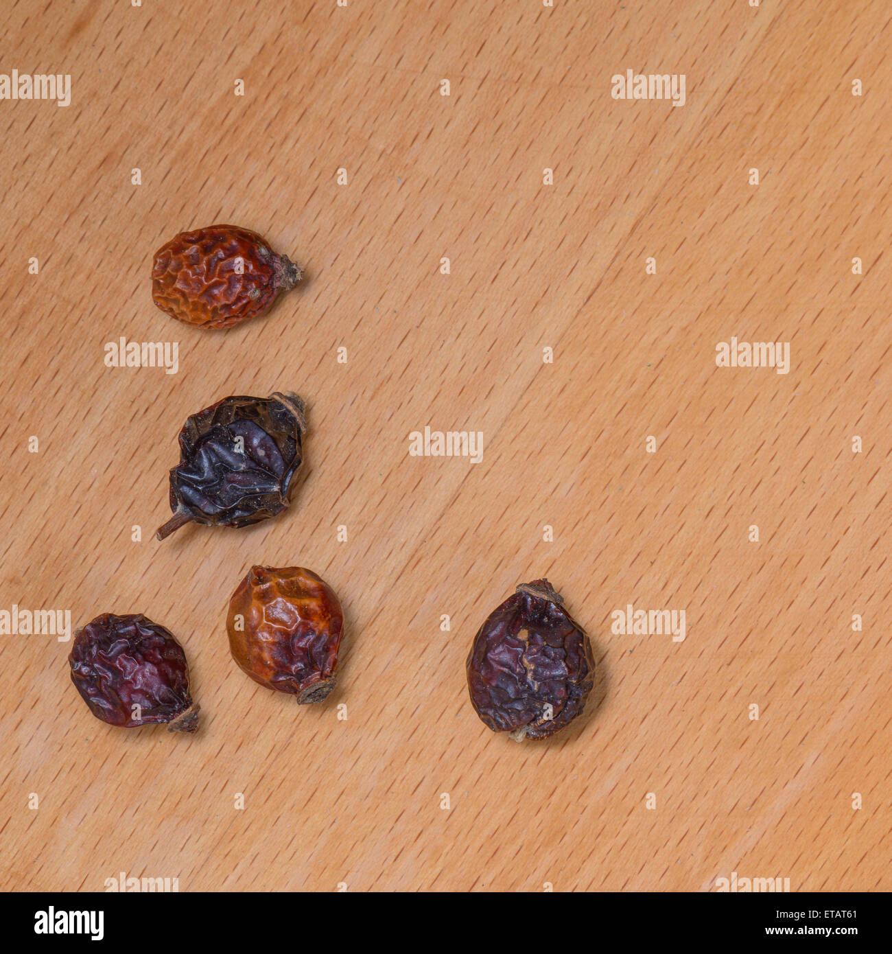 Dry Rosehip fruit for healty tisane on wood Stock Photo