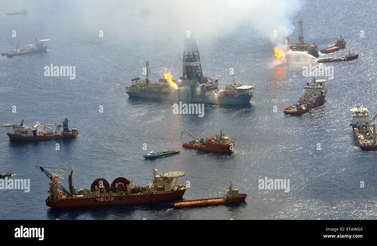 The Discoverer Enterprise and the Q4000 continue to flare off gasses as vessels gather around the ruptured riser at the BP Deepwater Horizon oil spill disaster site as efforts to contain the gusher continue June 26, 2010 in the Gulf of Mexico. Stock Photo