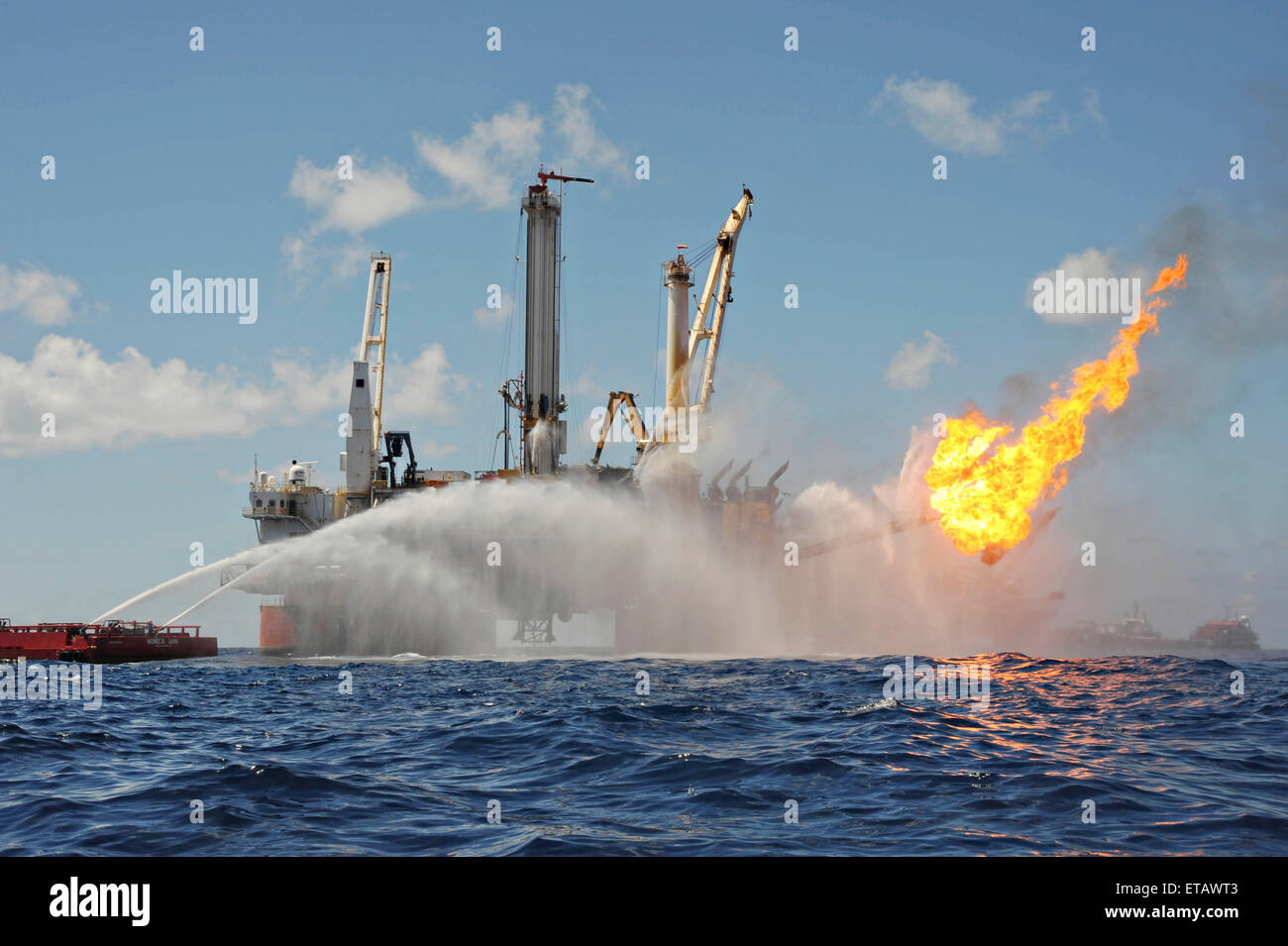 The mobile offshore drilling unit Q4000 continues to work to control the damaged Deepwater Horizon as crews work to plug the wellhead as the Deepwater Enterprise burns gas and oil flowing from the well July 9, 2010 in the Gulf of Mexico. Stock Photo