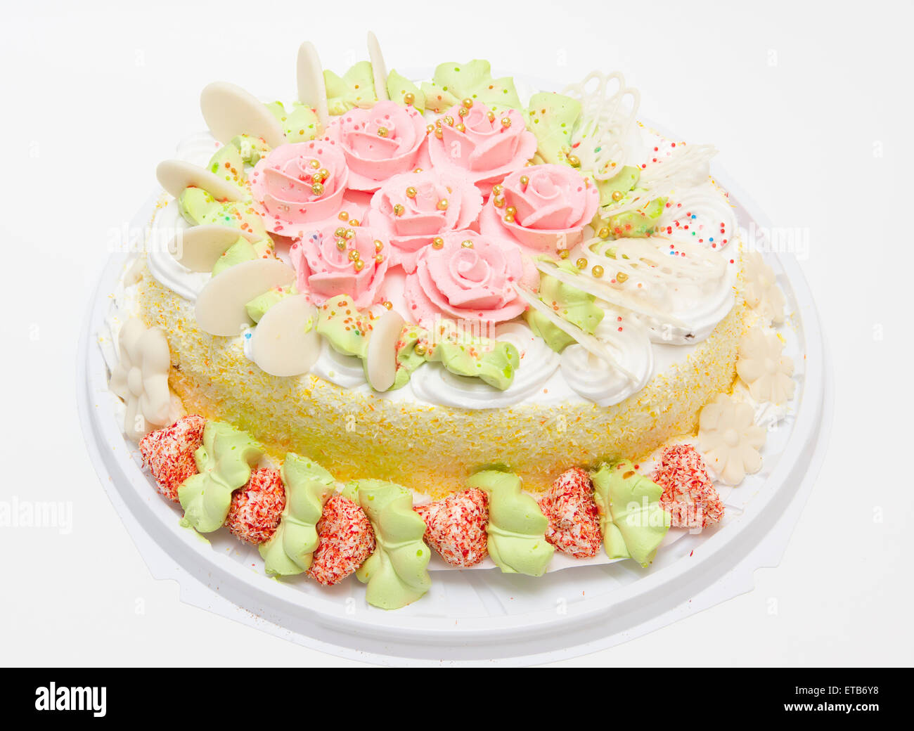 the big sweet pie decorated with cream roses on white background Stock Photo