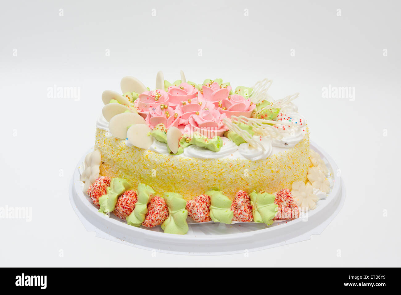 the big sweet pie decorated with cream roses on white background Stock Photo