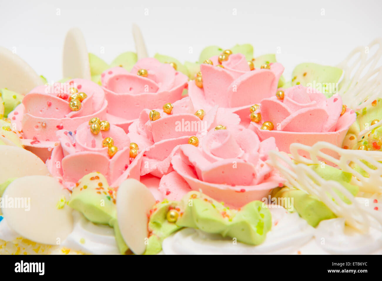 the big sweet pie decorated with cream roses on white background Stock Photo