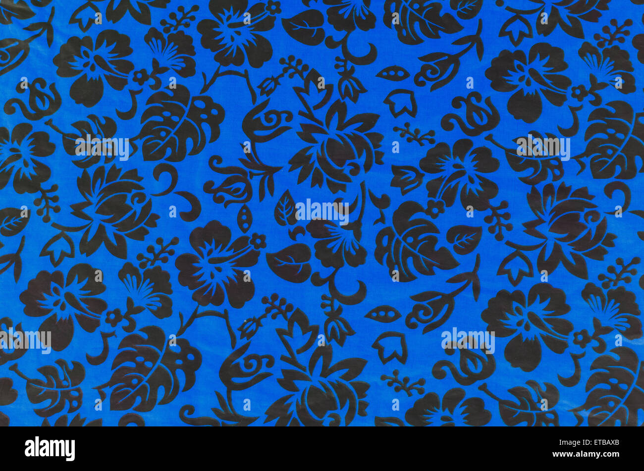 Blue Hawaiian fabric with black flowers Stock Photo