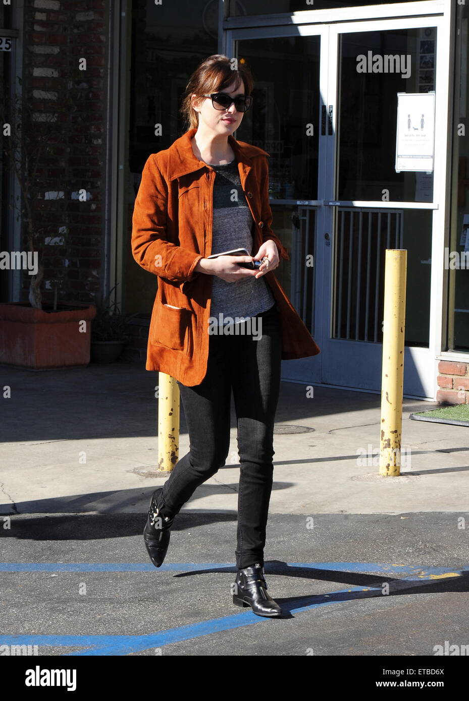 'Fifty Shades of Grey' star Dakota Johnson is all smiles after picking up her dry cleaning in Los Angeles. Afterwards, the actress headed out for lunch to Homestate cafe with a male friend  Featuring: Dakota Johnson Where: Los Angeles, California, United States When: 14 Jan 2015 Credit: Cousart/JFXimages/WENN.com Stock Photo