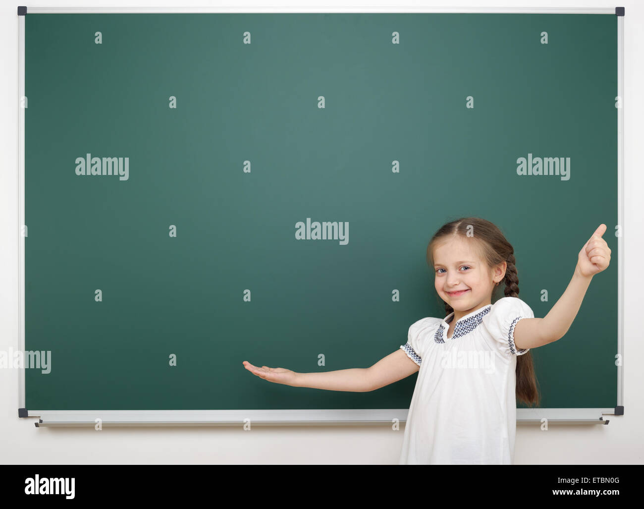 Schoolgirl near school board Stock Photo - Alamy