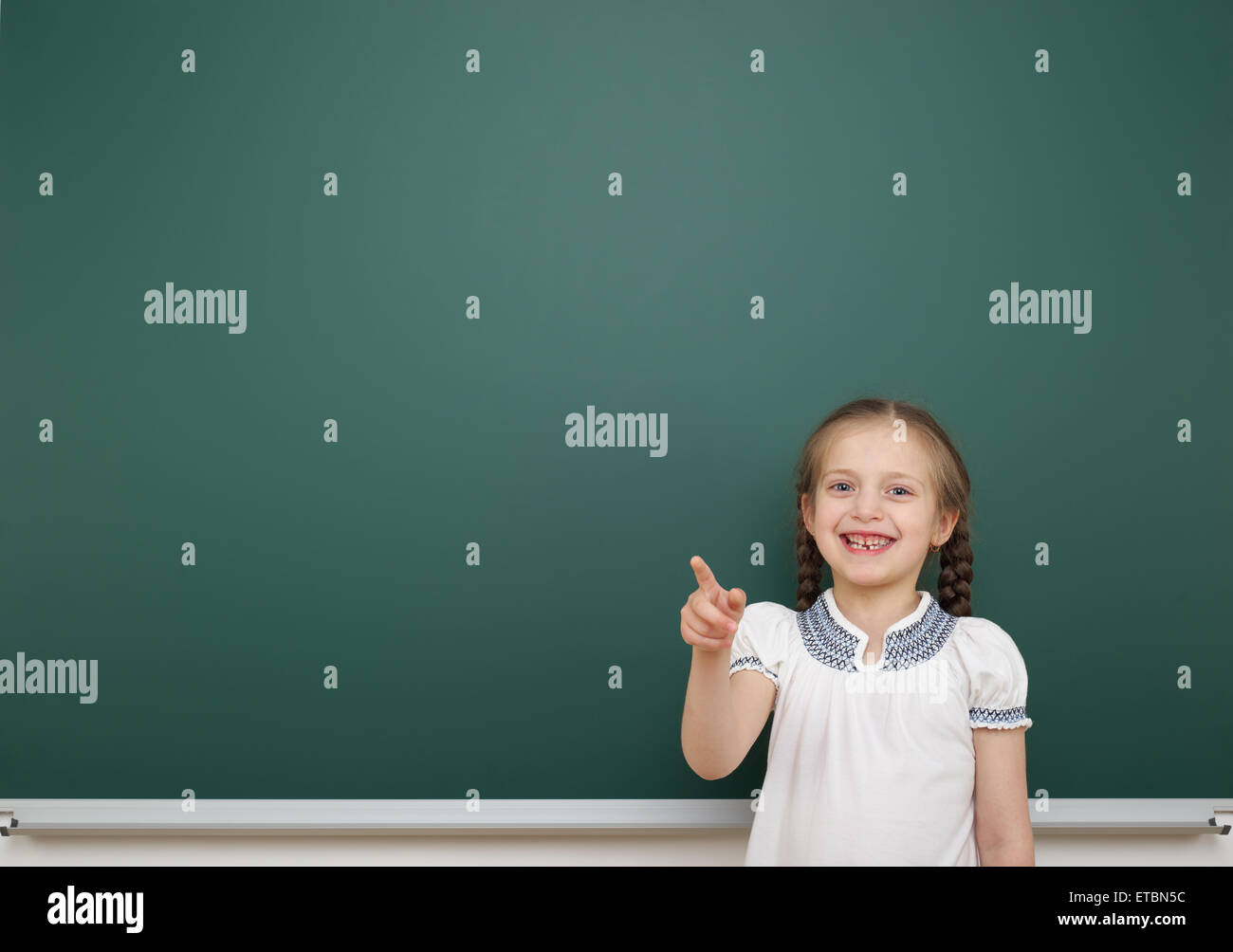 Schoolgirl near school board Stock Photo - Alamy