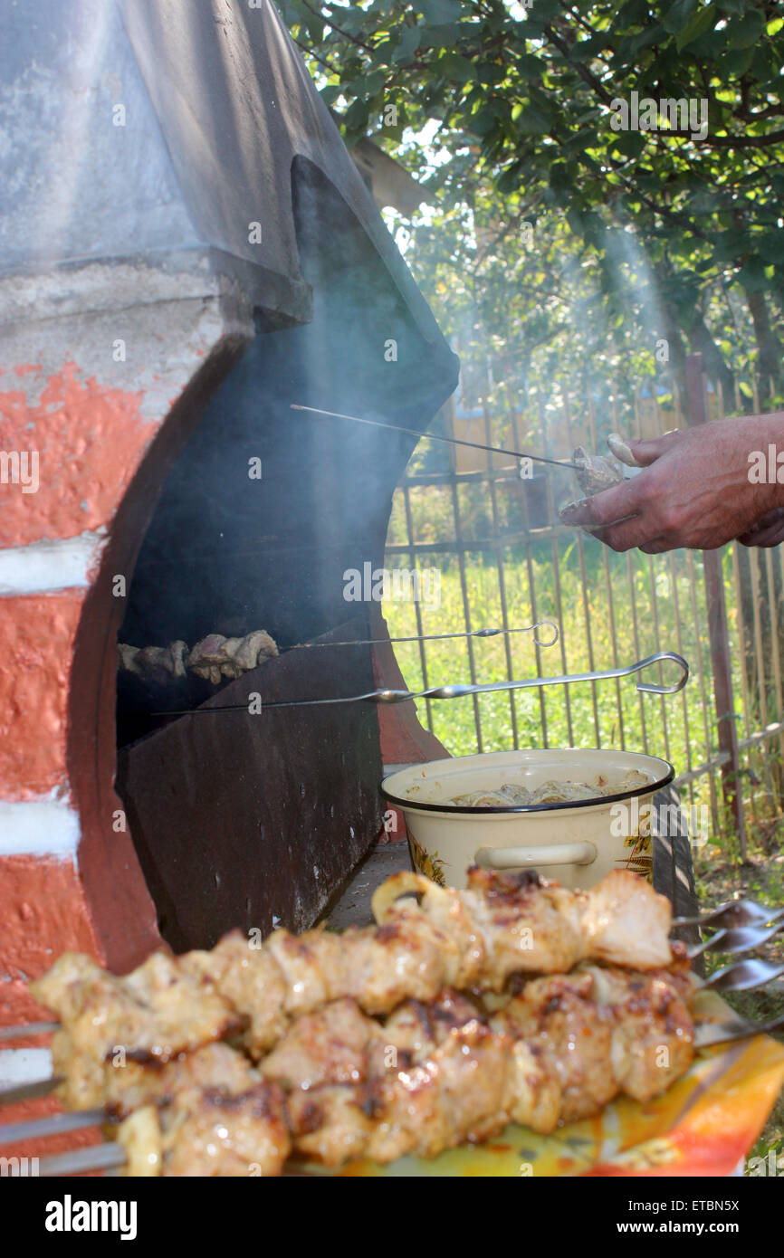 human hands roasting appetizing  barbecue from pork on the fire Stock Photo