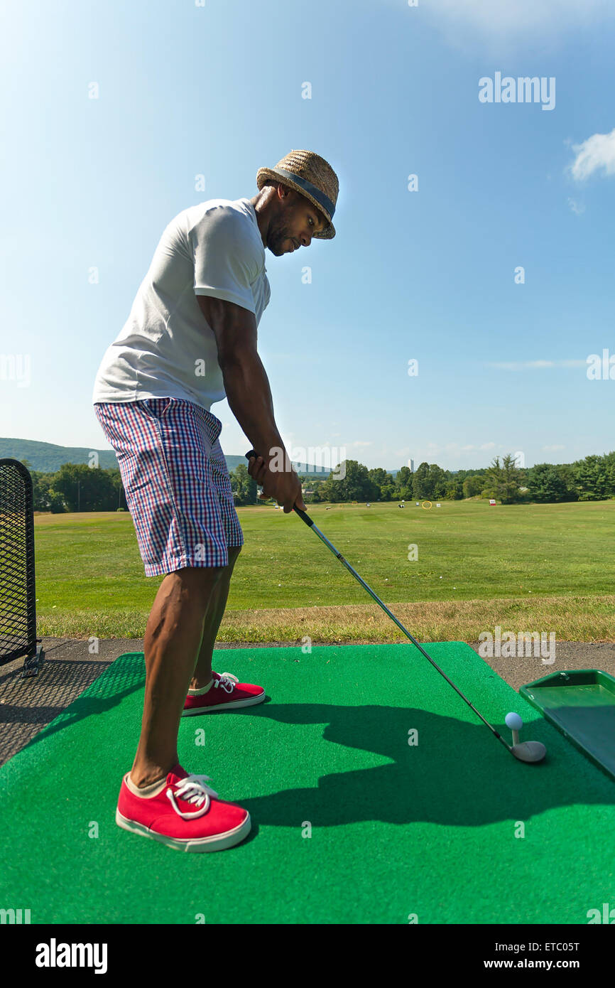 Golfer Teeing Up at the Driving Range Stock Photo