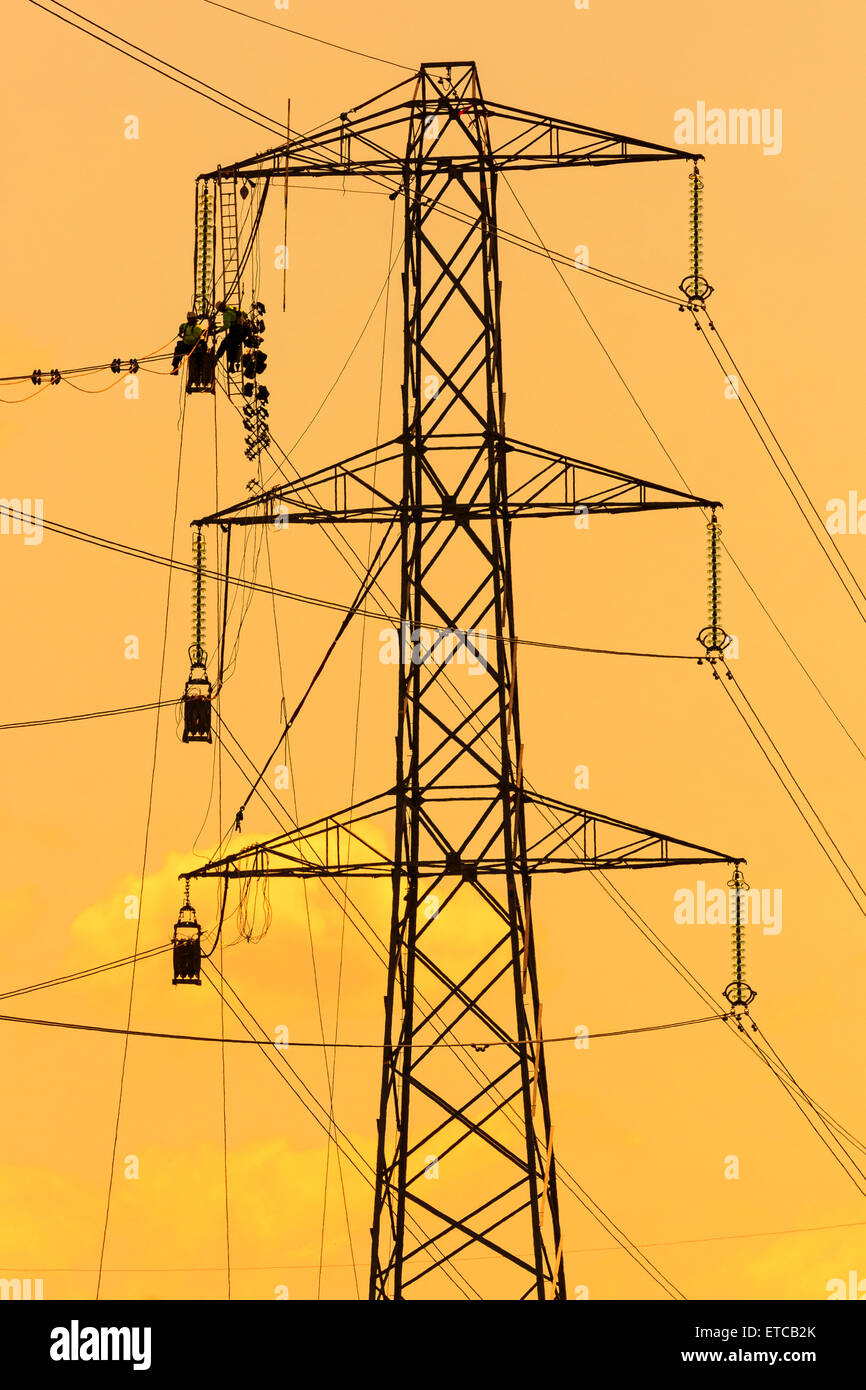 Engineer working on a high voltage power line near Glasgow, Scotland Stock Photo