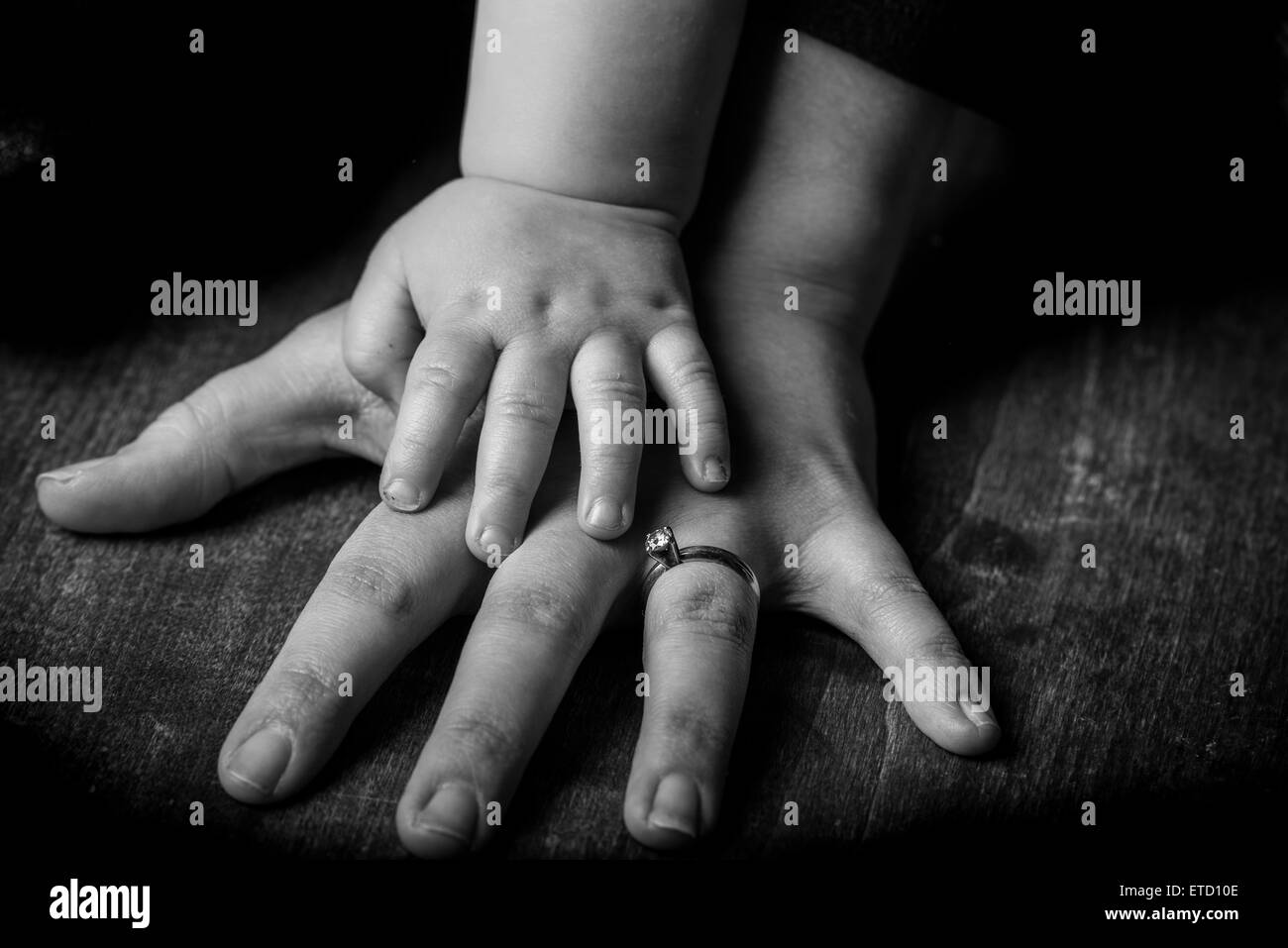 Hands of a mother and young baby. Stock Photo